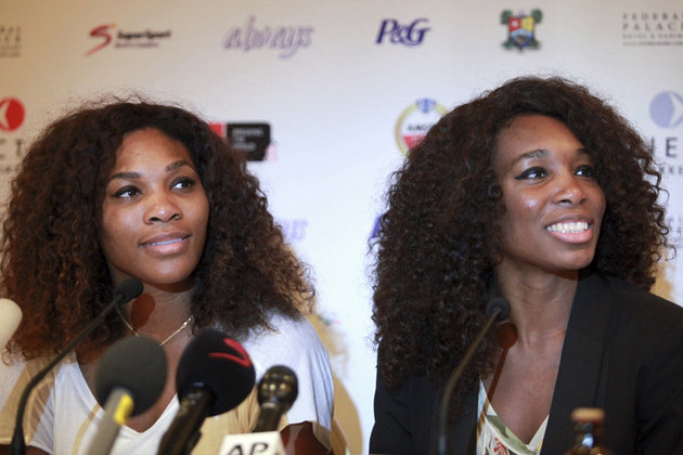 U.S tennis players Serena Williams and Venus Williams smile during a news conference in Lagos