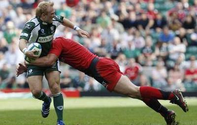 London Irish's Geraghty is tackled by Toulouse's Pelous during their rugby union Heineken Cup semi-final at Twickenham