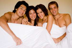 two-couples-sleeping-in-bed-300