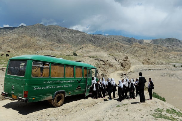 Afghan schoolgirls board a bus in Qara Zaghan village in Baghlan province on May 7, 2013. Afghanistan's education minister has threatened to punish students over cases when schools are hit by alleged "poisonings" that many officials believe are actually temporary psychological illnesses. Scores of girls' schools over recent years have seen mysterious mass fainting's, nausea and similar symptoms that are often blamed by police and media on Taliban insurgents or toxic gas leaks. AFP PHOTO/ SHAH Marai (Photo credit should read SHAH MARAI/AFP/Getty Images)