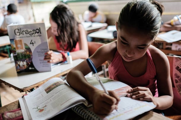 Girls attend a class at a school in the forest in Xapuri, Acre State, in northwestern Brazil, on October 8, 2014. Xapuri has the world's only producer of contraceptives harvested from the latex of the tropical forest. The Natex factory was founded in 2008 at Xapuri in the Amazonian state of Acre in Brazil's far north, a place known for the struggles of famous conservationist Chico Mendes, a rubber tapper gunned down in 1988 by local ranchers engaged in deforestation. AFP PHOTO / YASUYOSHI CHIBA (Photo credit should read YASUYOSHI CHIBA/AFP/Getty Images)