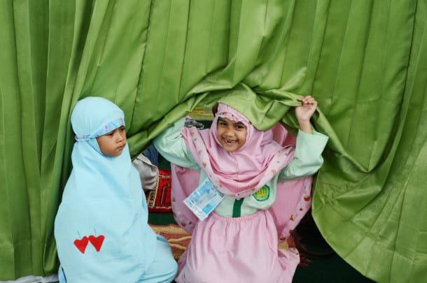 Two Islamic school children prepare for prayer during a school trip in Jakarta on October 18, 2012. AFP PHOTO / ADEK BERRY (Photo credit should read ADEK BERRY/AFP/Getty Images)