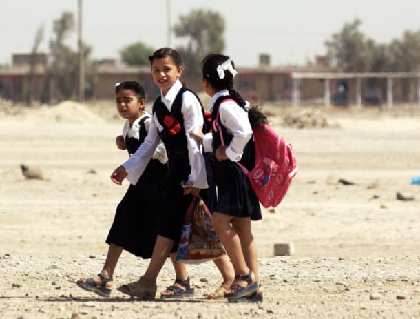 TIKRIT, Iraq: Iraqi school girls walk home in Tikrit, 170 kms north of Baghdad, 22 September 2005. A joint Iraqi-US military operation to uproot rebels from the northern town of Tal Afar has been successfully completed, the Iraqi operational commander said. AFP PHOTO/Tauseef MUSTAFA (Photo credit should read TAUSEEF MUSTAFA/AFP/Getty Images)