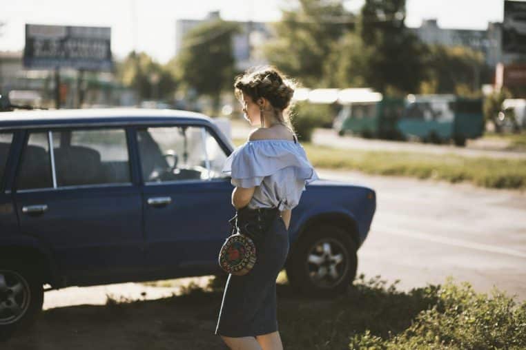 Woman Walking Near Sedan