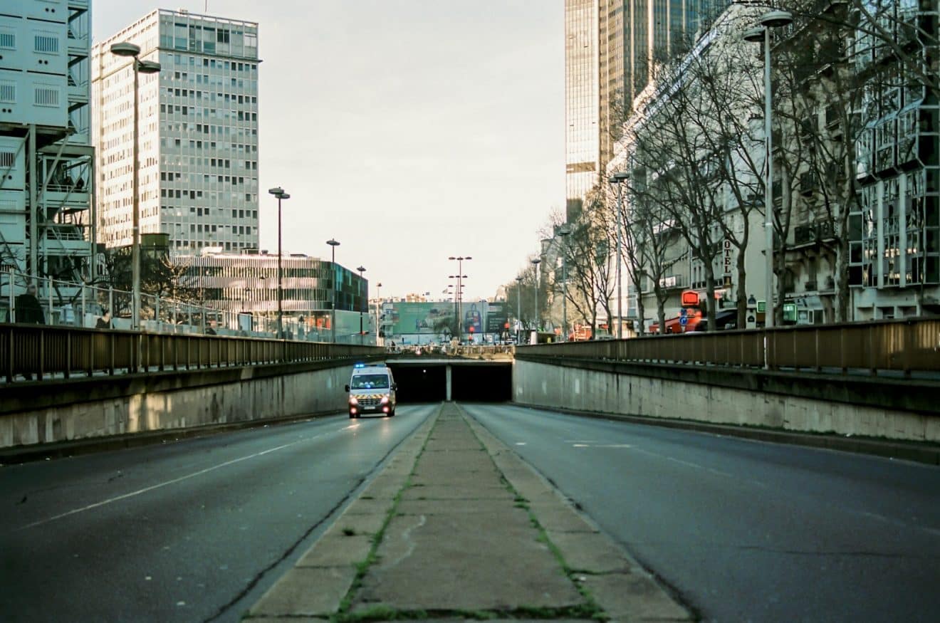 gray concrete road near high rise buildings during daytime